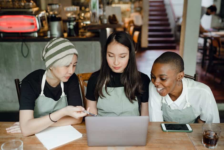 people looking at a laptop - direct primary care services for small businesses