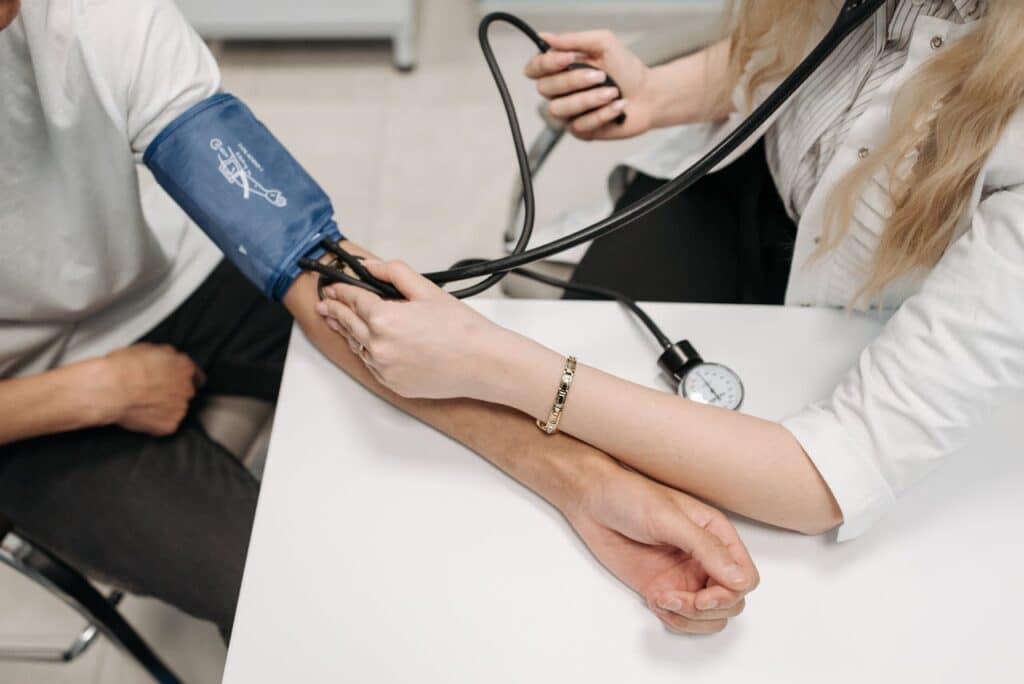 doctor and patient blood pressure monitoring - Early disease detection in Direct Primary Care