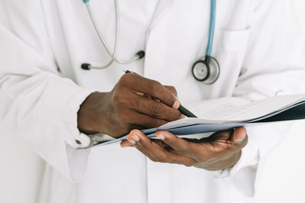 doctor writing notes - Direct Primary Care fee structure